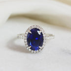 Oval Blue Sapphire Engagement Ring: 18K White Gold Halo, Moissanite Accents
