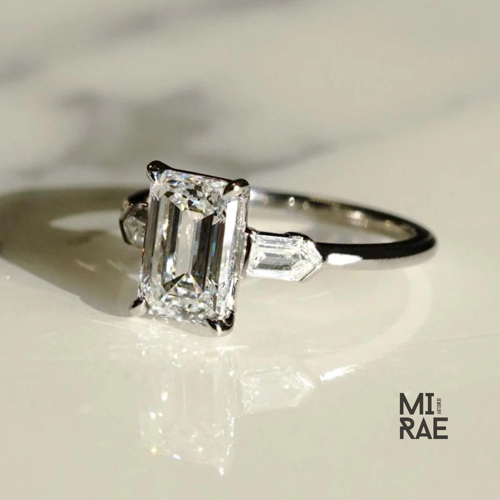 Emerald Cut Moissanite Three Stone Ring: 18K White Gold & Baguette Accents